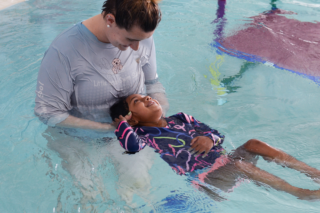Intro to water swim lessons includes learning how to be comfortable under the water and floating on their face and on their back