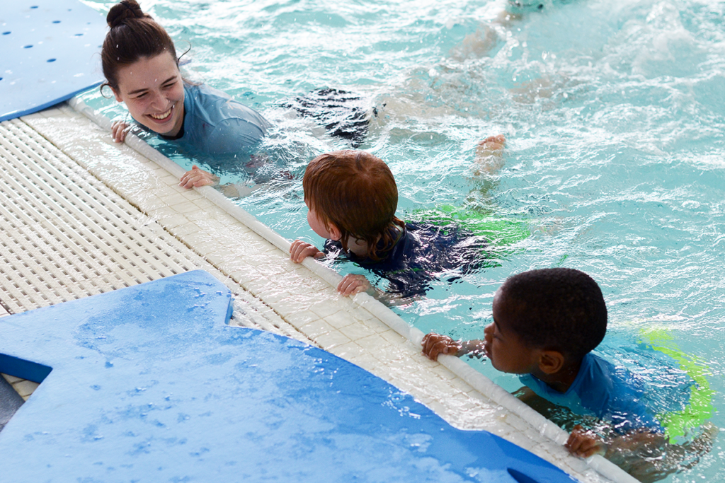 Intro to water swim lessons includes learning how to be comfortable under the water and floating on their face and on their back