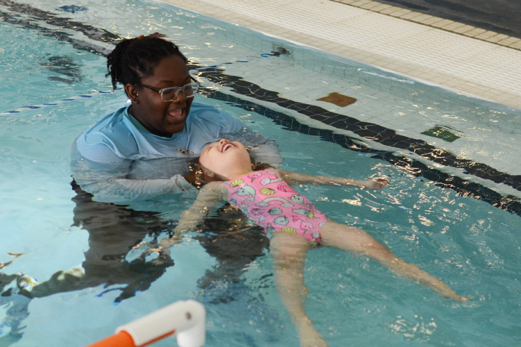 Intro to water swim lessons includes learning how to be comfortable under the water and floating on their face and on their back