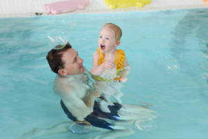 Otter baby and you swim classes at litter otter, parents in the pool with their babies learning swim skills, essential safety skills