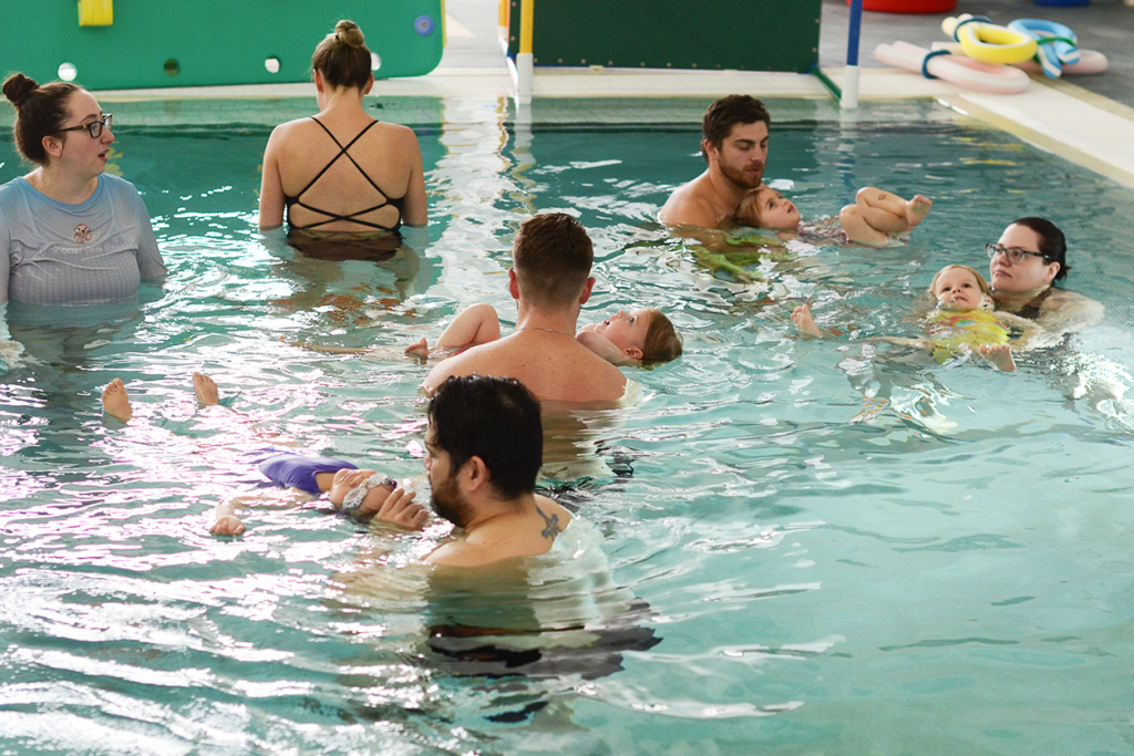 Otter baby and you swim classes at litter otter, parents in the pool with their babies learning swim skills, essential safety skills