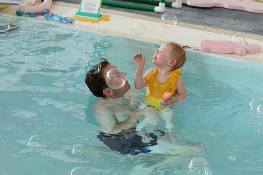 Otter baby and you swim classes at litter otter, parents in the pool with their babies learning swim skills, essential safety skills