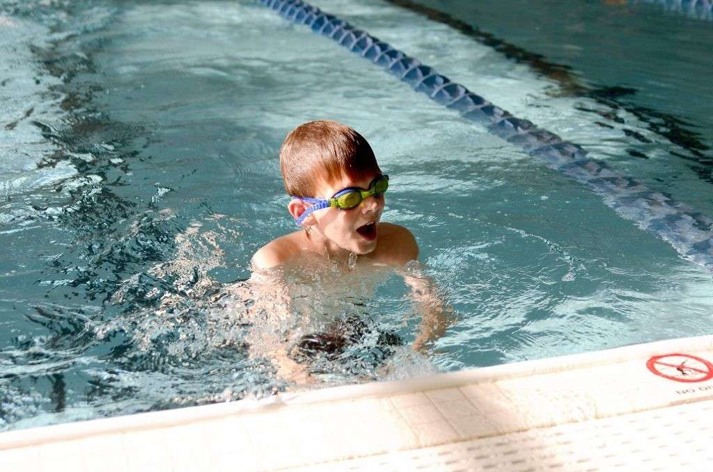 Child practicing stroke proficiency in a swim class pool, Charlotte & Huntersville, NC