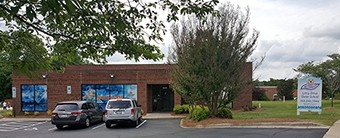 Little Otter swim school exterior in Charlotte with parking and facility signage